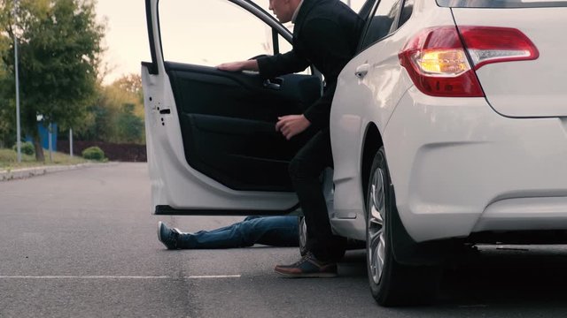 The driver hit a pedestrian and runs out of the car