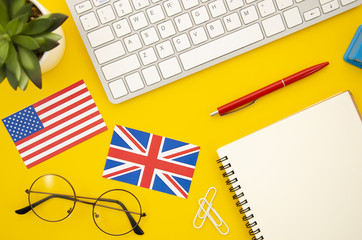 American and great britain flags next to empty notebook