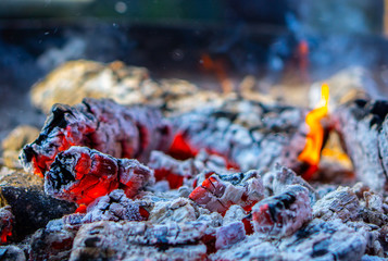 burning, glowing wood in the day