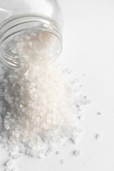 Scattered flavored salt on white background
