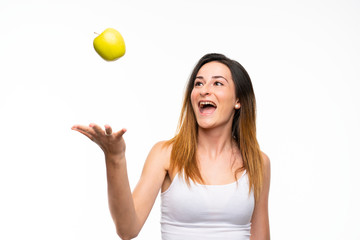 Young woman with an apple over isolated white background