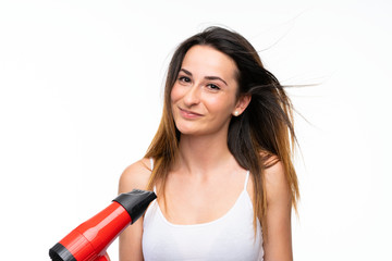 Young woman with hairdryer over isolated background