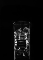 Vodka or gin tonic with ice in rocks glass on black background