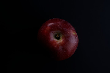 red apple on black background