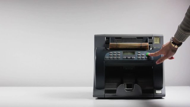woman starts counting machine with bitcoin bills slow motion