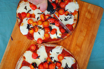 Pizza with fresh cherry tomatoes, mozzarella and opal basil on a cauliflower crust