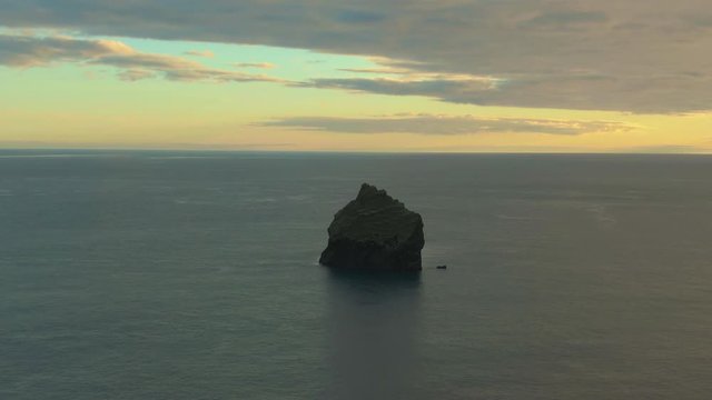 Cliff in Sea at Sunset. Reykjanes Peninsula. Iceland. Aerial View. Drone is Orbiting
