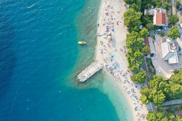 An aerial shot of people enjoying the beach on a sunny day