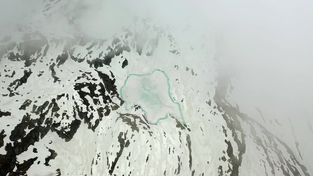 Aerial: Beautiful Frozen Lake Among Amazing Snowy Mountains - Le Brevent, France