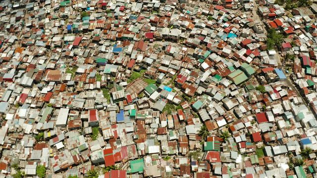 Streets of poor areas in Manila. The roofs of houses and the life of people in the big city. Poor districts of Manila, view from above. Manila, the capital of the Philippines.