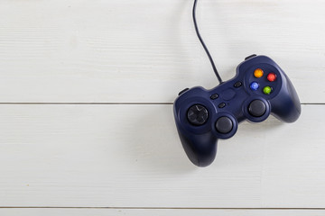 Retro computer gaming controllers placed on wooden background. Home video games time concept. © Alex Ishchenko