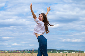 Young brunette woman in white shirt and blue jeans shorts