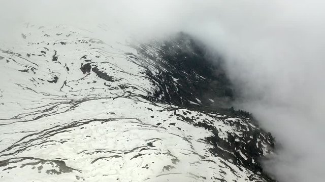 Aerial: Amazing Snowy Mountain in Thick Clouds - Le Brevent, France
