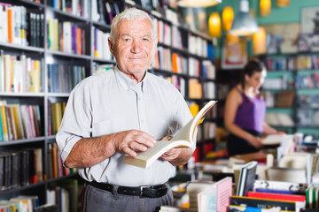 Person 61-67 years old is choosing book for reading in free time