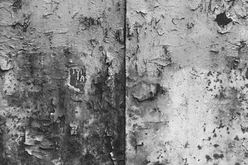 Texture of an old worn out scratched the surface. Black and white grunge background, peeling paint.