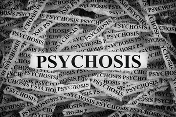 Torn pieces of paper with the word Psychosis