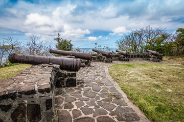 Medieval cannons on the hilltop of Fort Hamilton on Bequia Island,  St Vincent and the Grenadines, Lesser Antilles, Caribbean.