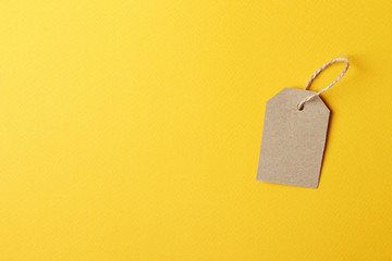 Cardboard tag with space for text on yellow background