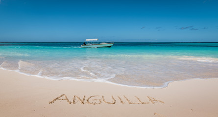 Beautiful tropical beach. Anguilla written in white sand. - obrazy, fototapety, plakaty