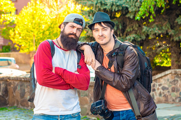 Two fashionable male friends photographer a partners posing together. Guys are 30 years old. Men 40...