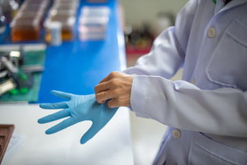 Staff are wearing gloves to work in the operating room in the hospital,select focus.