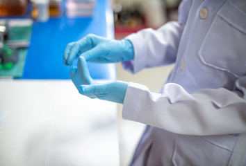 Staff are wearing gloves to work in the operating room in the hospital,select focus.