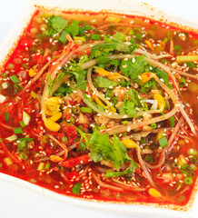 Yellow bean sprouts Vermicelli red soup in white porcelain bowl