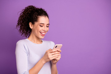Close-up portrait of her she nice attractive lovely cheerful cheery glad wavy-haired girl using cell chatting smm marketing comment isolated over violet lilac purple pastel color background