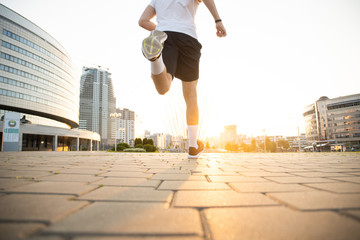 Fototapeta na wymiar Athlete runner feet running on road, Jogging concept at outdoors. Man running for exercise.