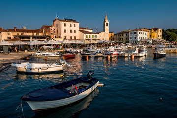 Fototapeta na wymiar Picturesque Village Fazana In Croatia With Old Church And Boats In Harbor