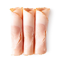 Three rolled up slices of chicken ham isolated on white. Top view.