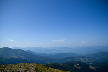 Landscape with mountains view from the top of Hoverla mountain which located in Ukraine with amazing sunny weather and blue sky as nature wallpaper for travel blog with famous places in summer time