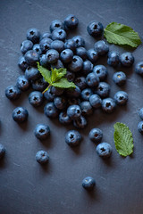 Aerial image of blueberries on blackboard with mint leaves