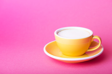 yellow cup on a pink background