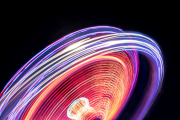 Colorful Light Trail From A Fast Carrousel At A Fun Park In The NIght