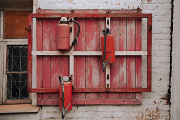 3 Fire extinguishers on the red old wall