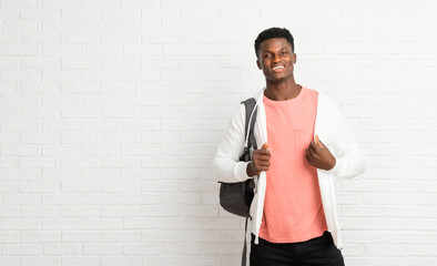 Young afro american man student proud and self-satisfied in love yourself concept