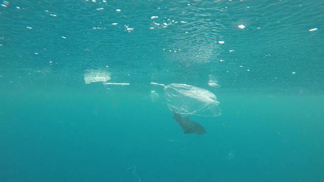 Plastic bags, straws and cups pollution underwater in sea 