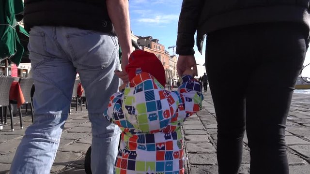 Parents walk with a child