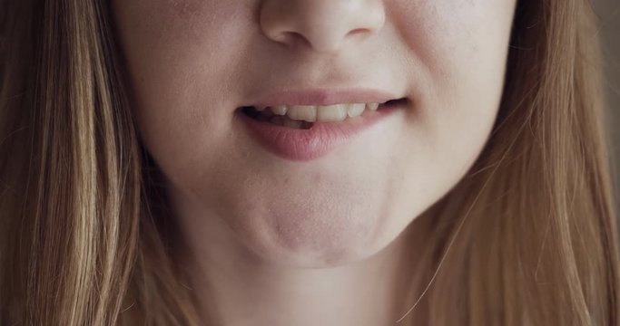 Girl bites lips and smiling with beautiful soft lips.