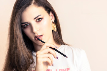 Obraz premium beautiful girl on white background. Girl holding pen for notes, glasses. The concept of beauty services, botox, skin care, modern fashion, blog, notes