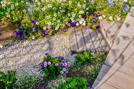 small pebble path in a beautiful flower garden