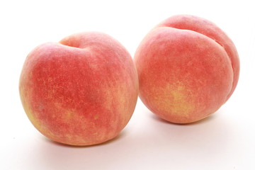 Ripe peaches on white background