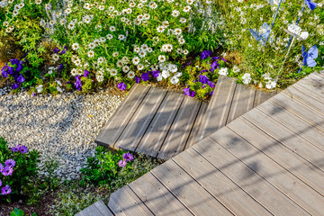 beautiful terrace and wooden driveway in the blooming garden