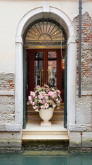 In Venice. View of the exit to water on one channel with a huge beautiful bouquet of flowers in a vase