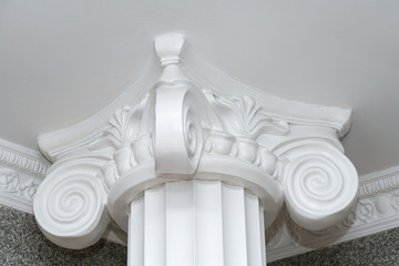 white natural concrete column capitals closeup. gypsum capitals