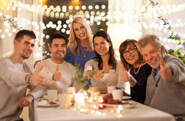 celebration, holidays and people concept - happy family having tea party at home