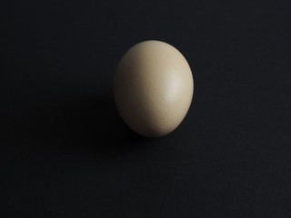 natural fresh chicken egg on black paper background