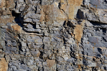 Rocks carved by sea water erosion. Stones texture and background. Rock texture