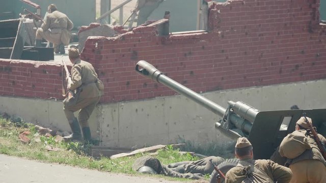 Soldiers shoot a cannon during the battle